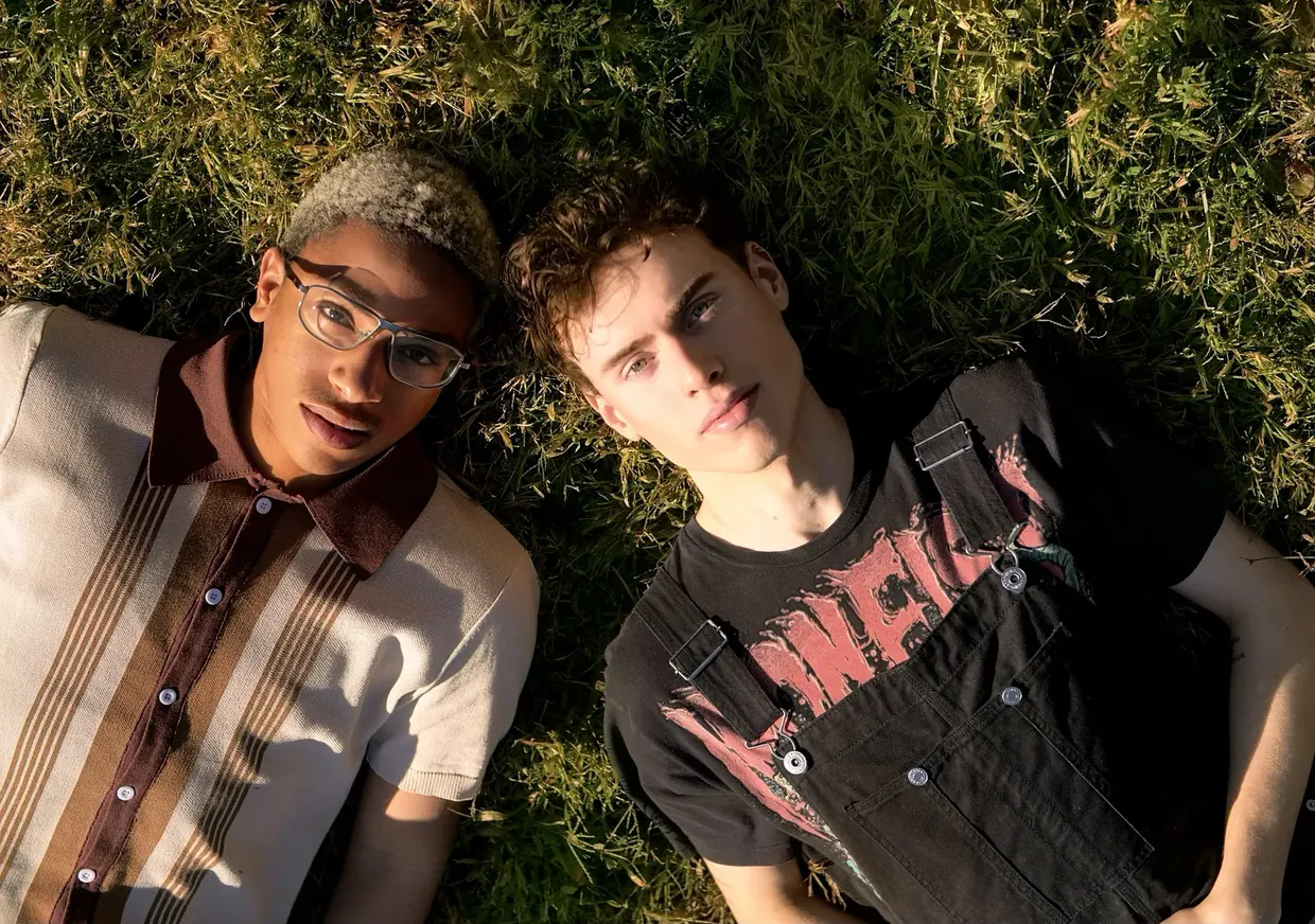 Two young people lying in long grass